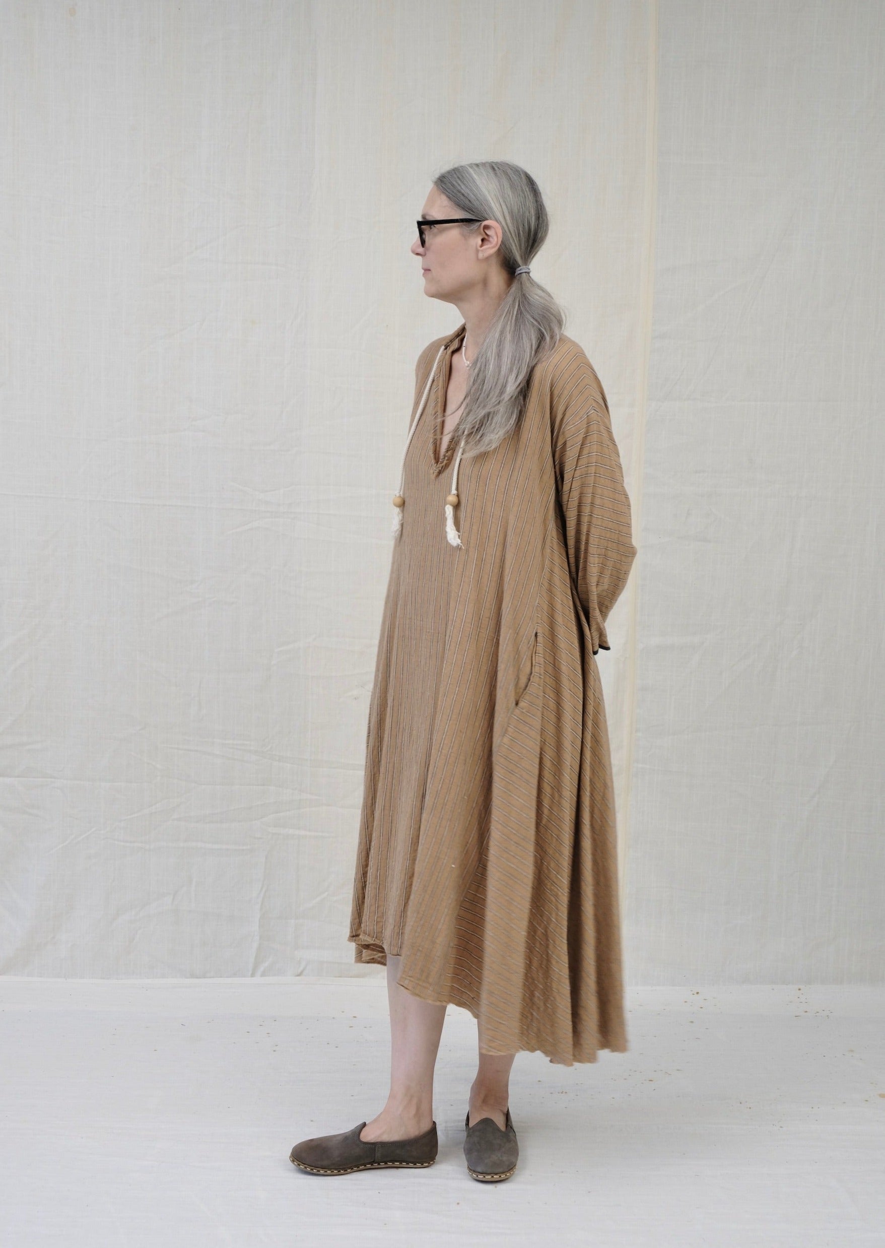 Dervish dress brown stripe on model side view