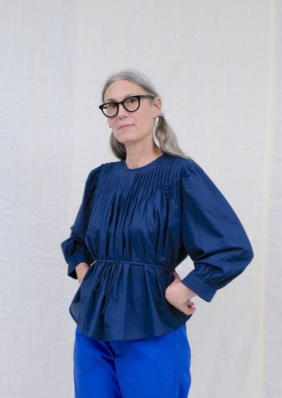 Indigo pintuck blouse on model