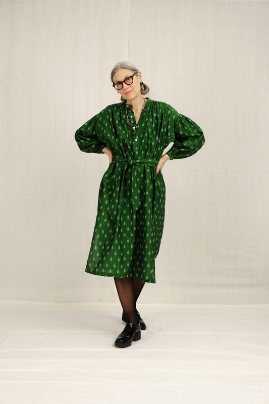 model wearing green belted dress