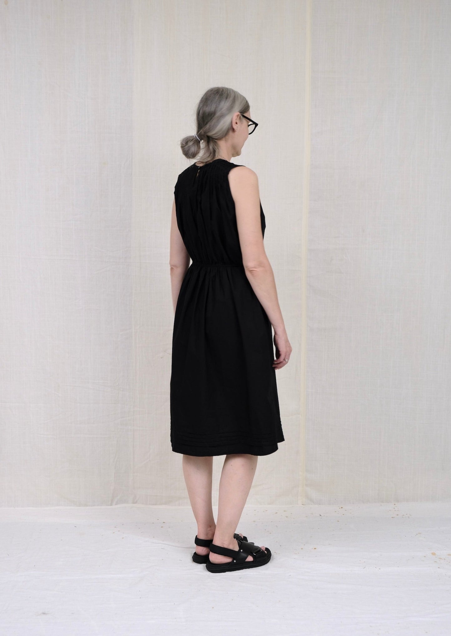 pintuck dress black poplin back view on model
