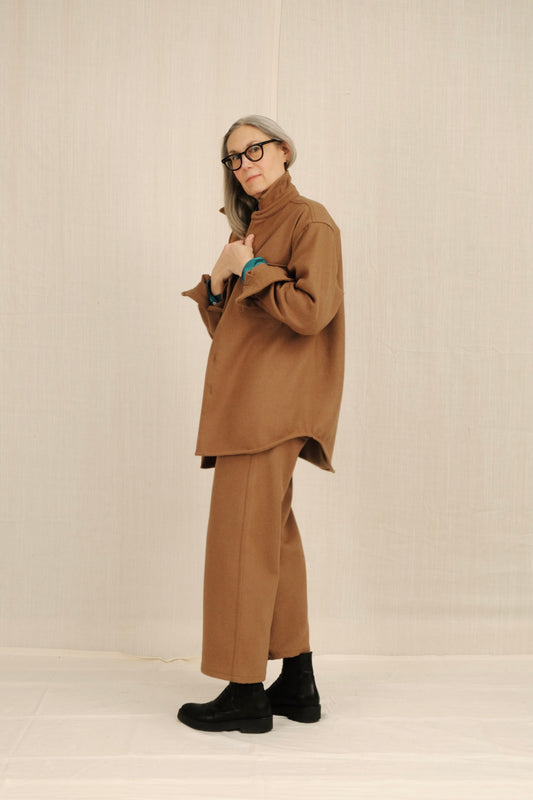 Person wearing a CAMEL WOOL outfit with a plain background