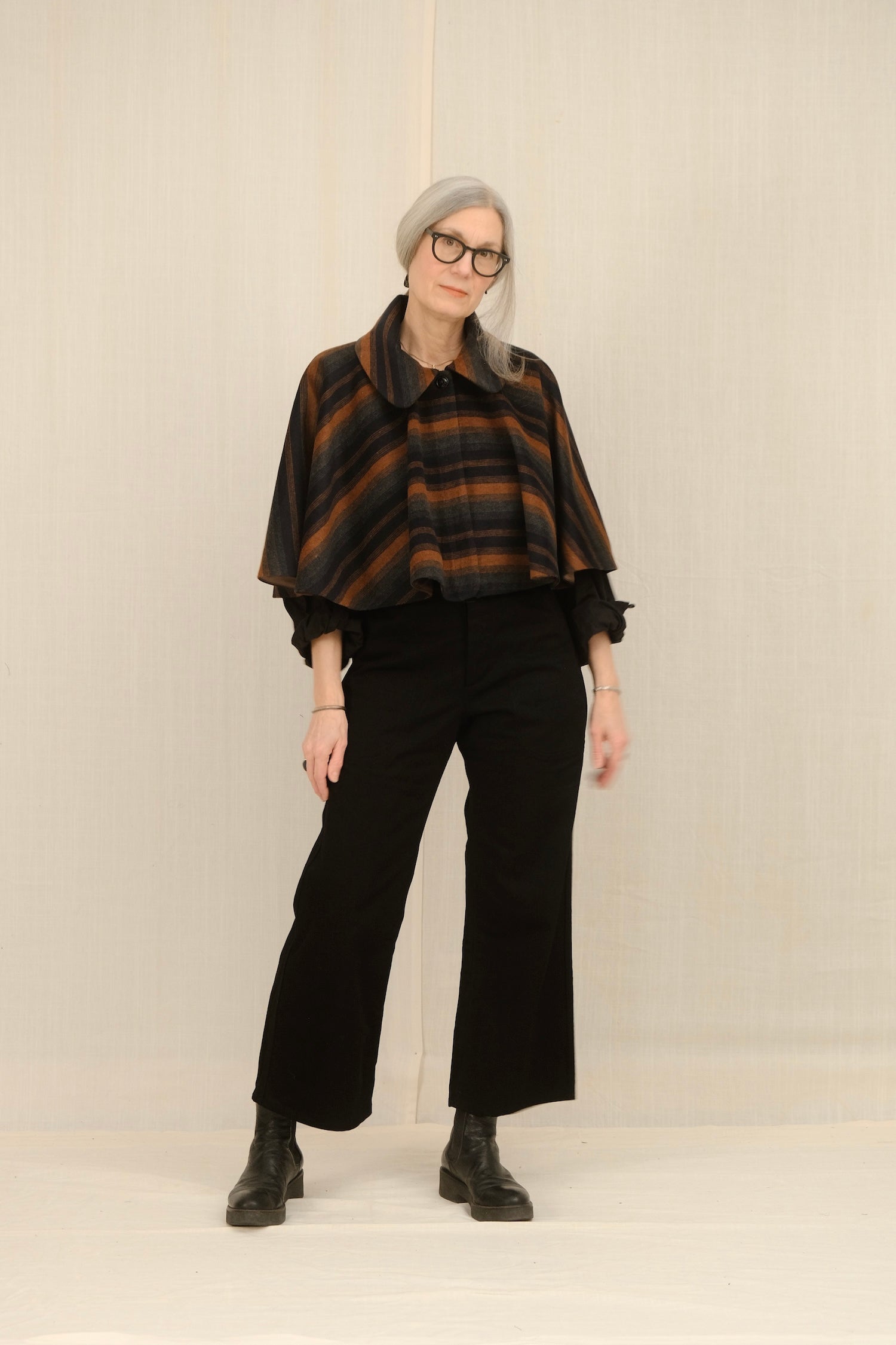 Person wearing a STRIPE CAPELET and NAVY WOOL SAILOR pants against a plain background