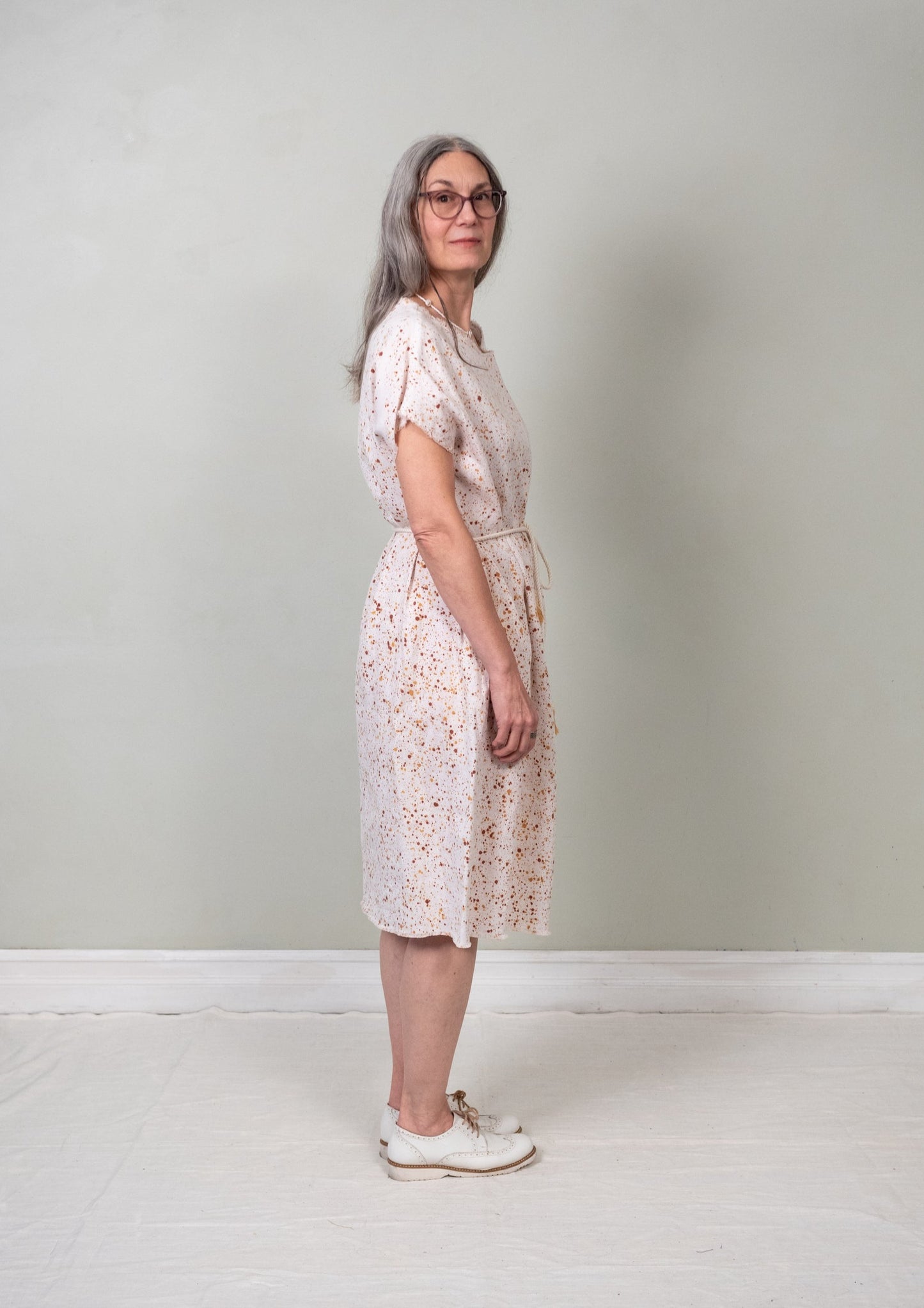 belted paint-splatter sack dress side view