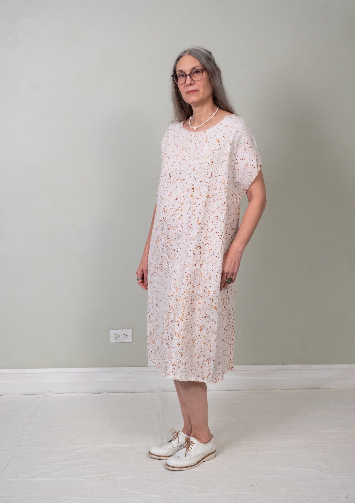 unbelted paint-splatter sack dress 3/4 view