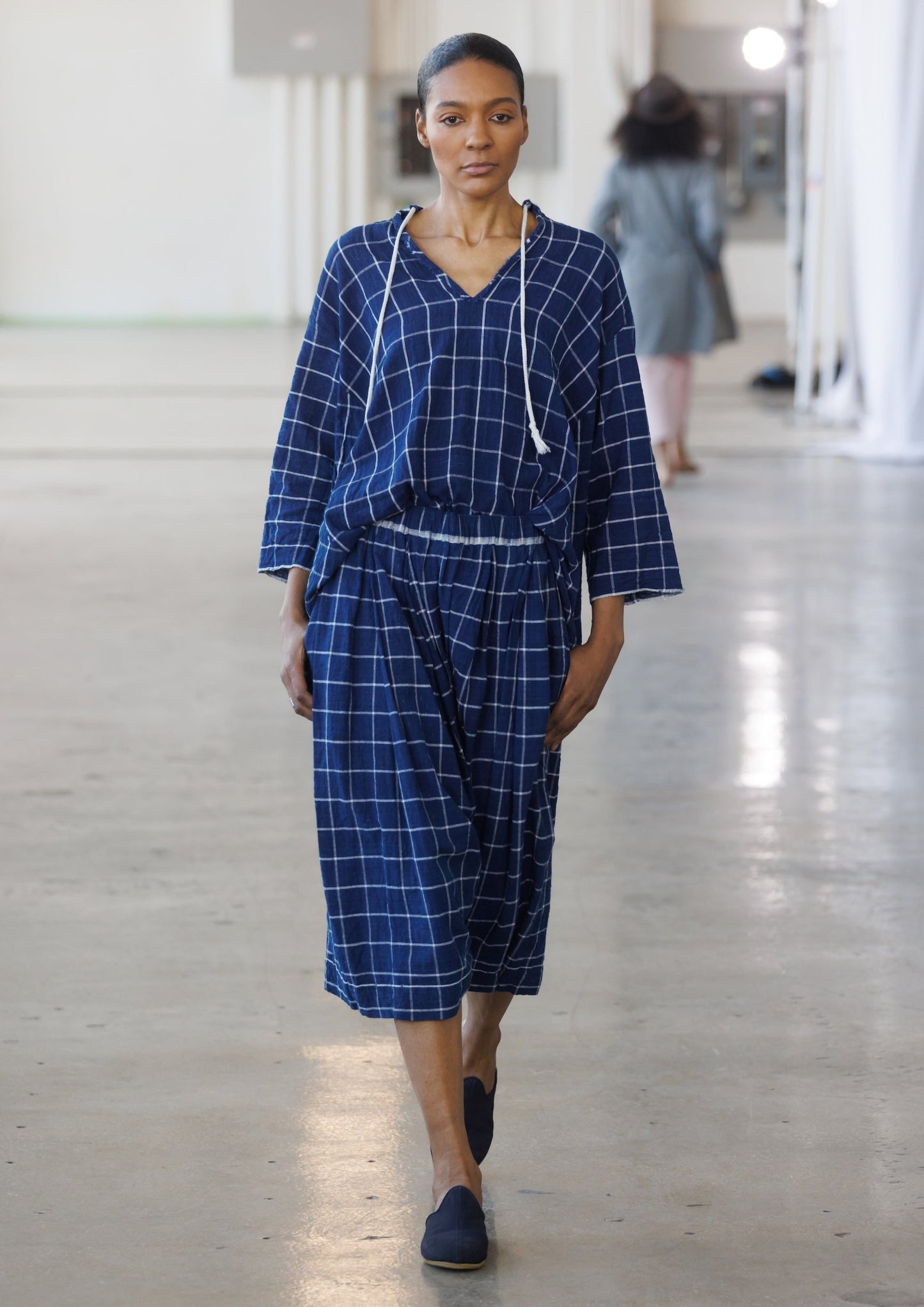 runway model in windowpane top and skirt