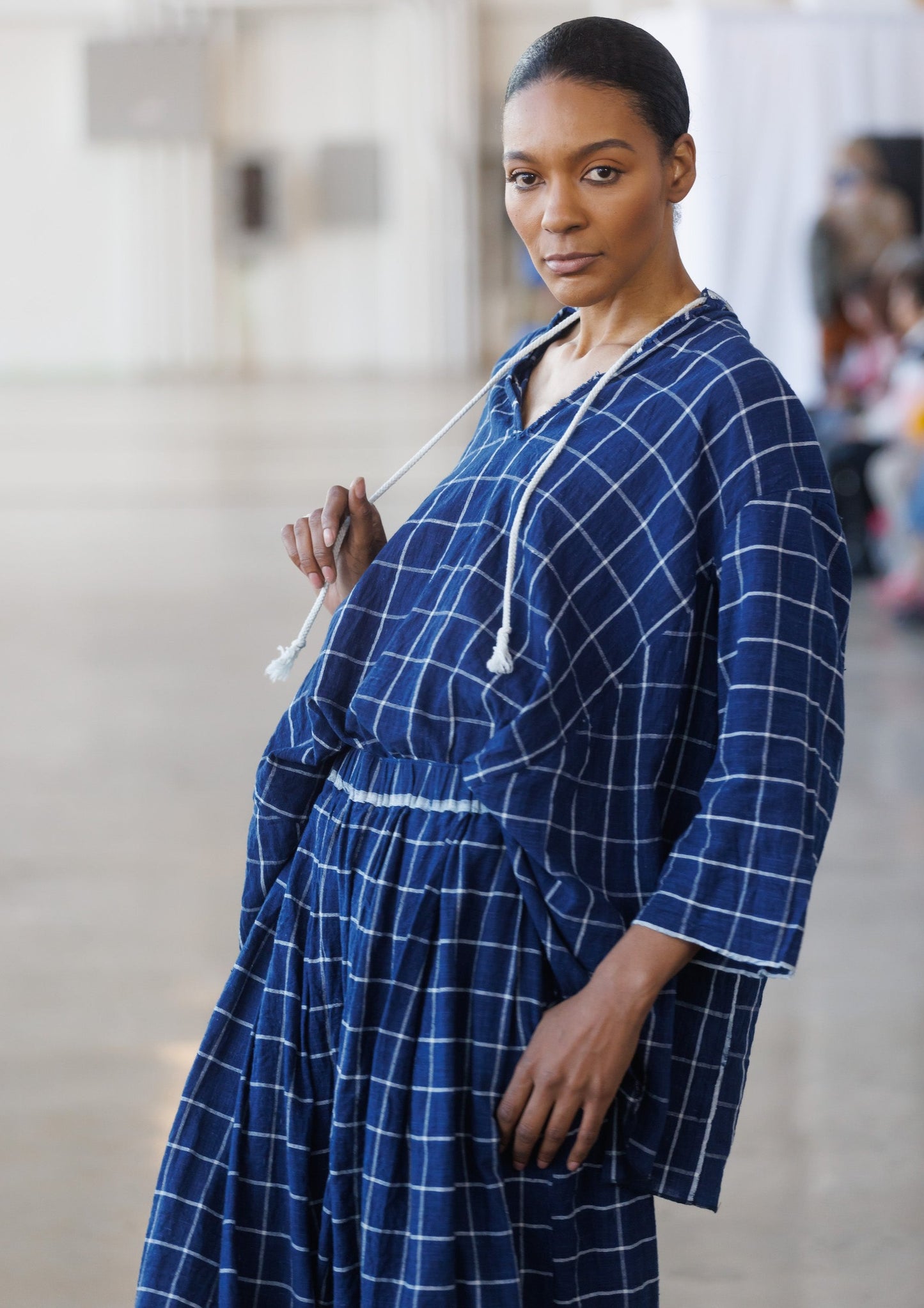 3/4 view runway model in windowpane top and skirt