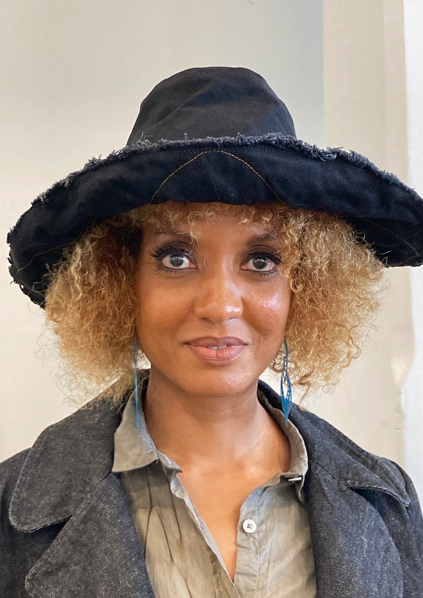 CLOSEUP OF BLACK HAT ON MODEL