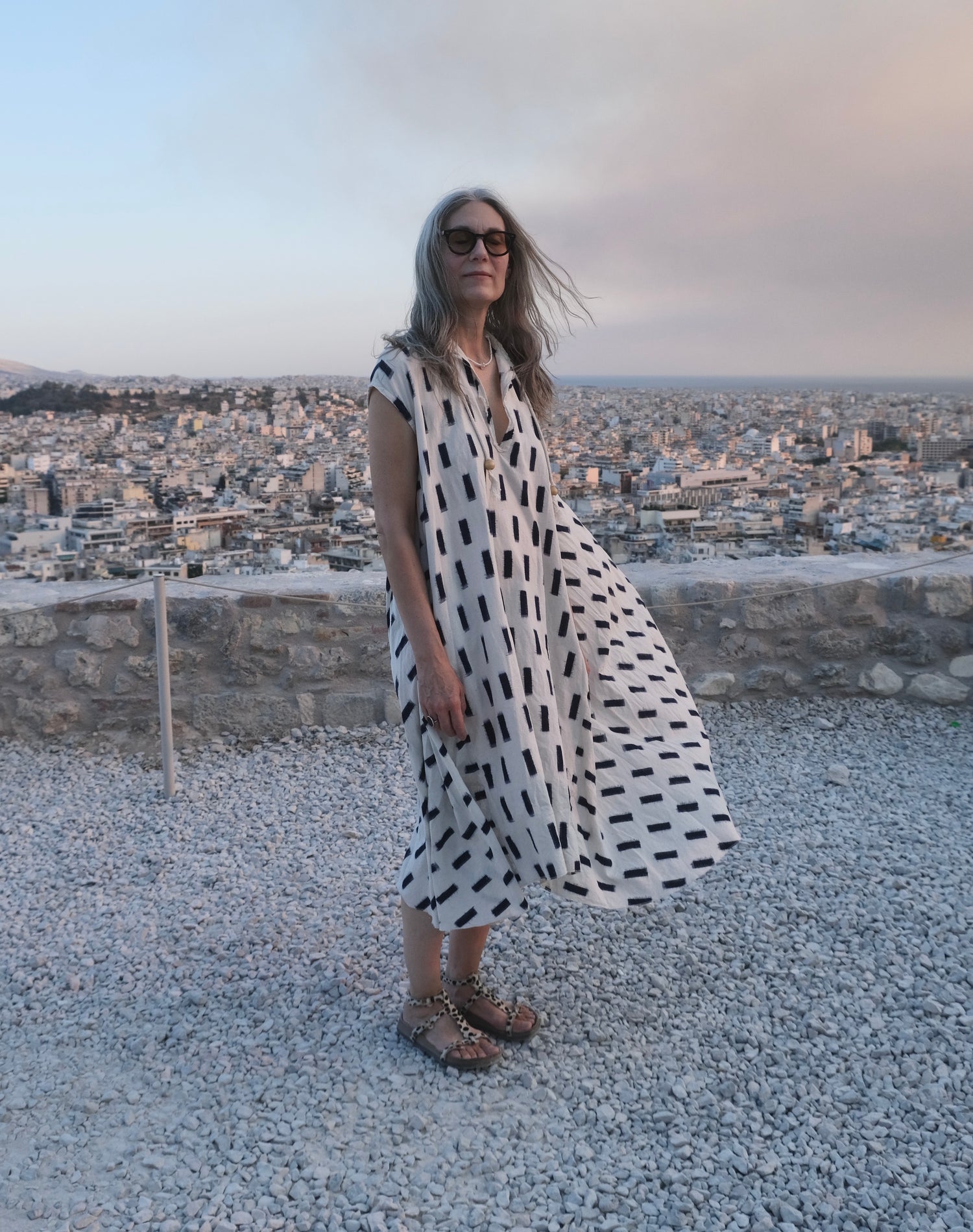Model on Acropolis in Sleeveless Dervish Dress Natural and indigo brick ikat