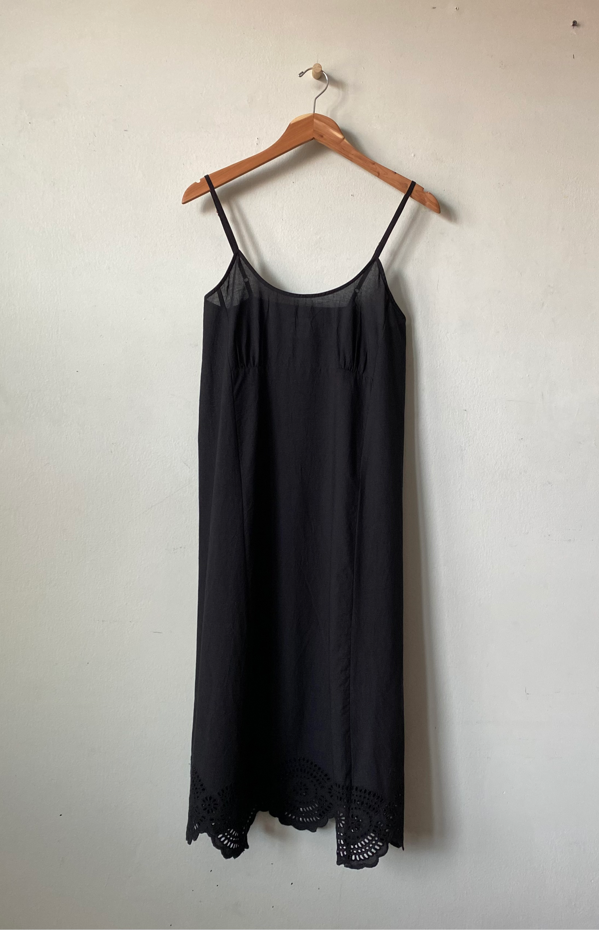 black slip dress on a hanger