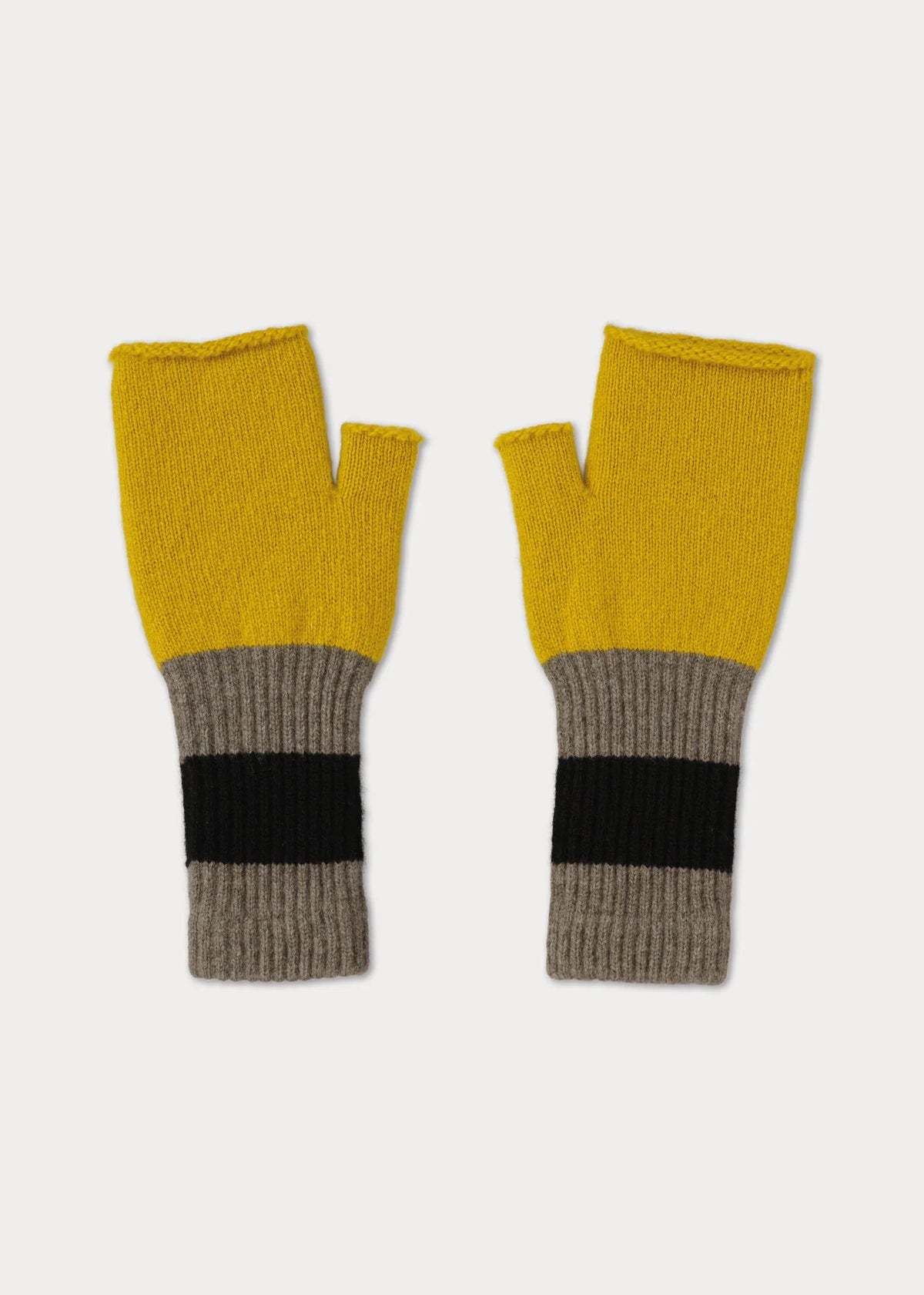 Pair of mustard yellow and gray fingerless gloves on a light gray background